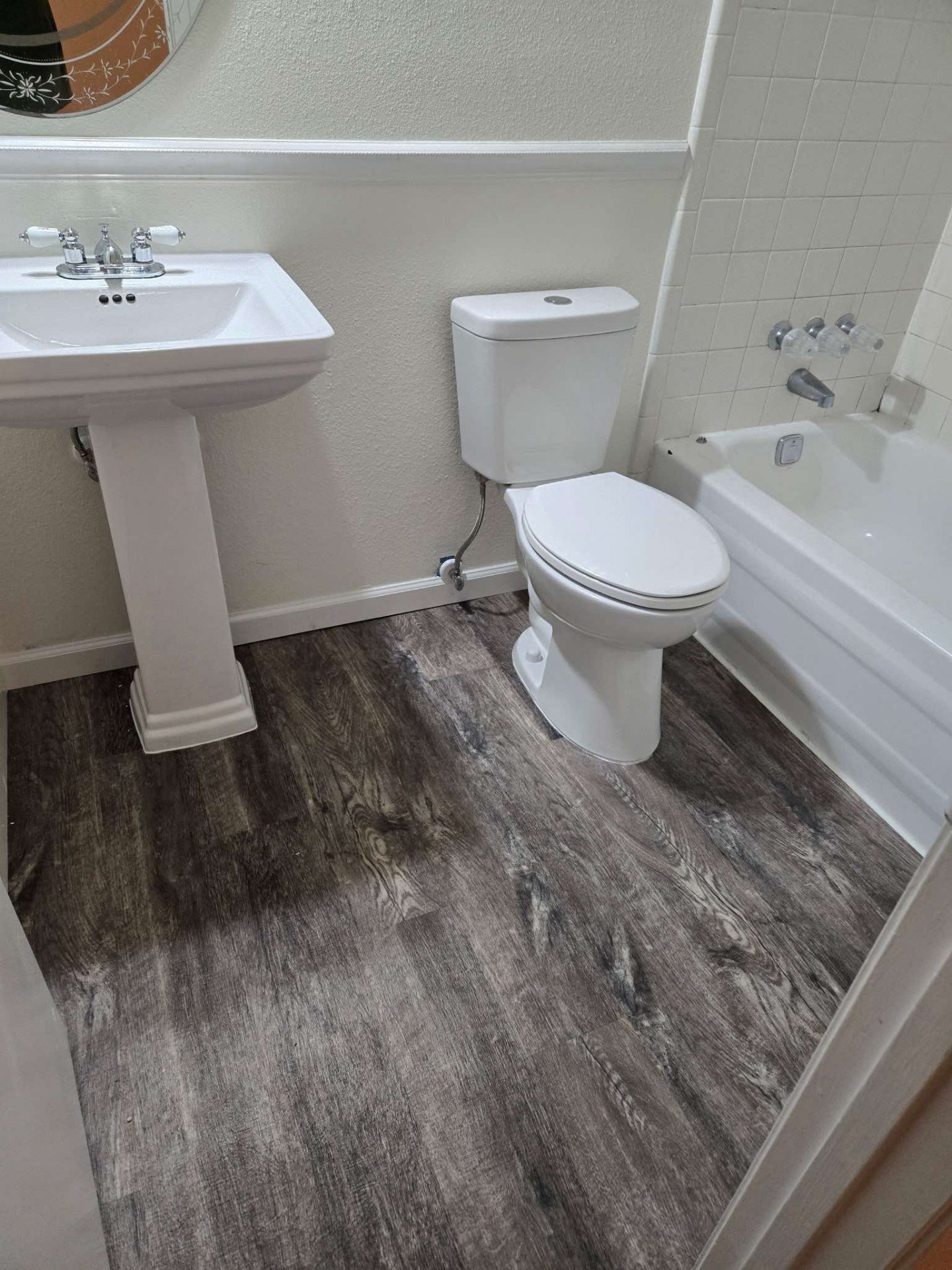 Bathroom waterproof vinyl plank flooring installation featuring moisture-resistant LVP perfect for wet areas bathrooms and powder rooms