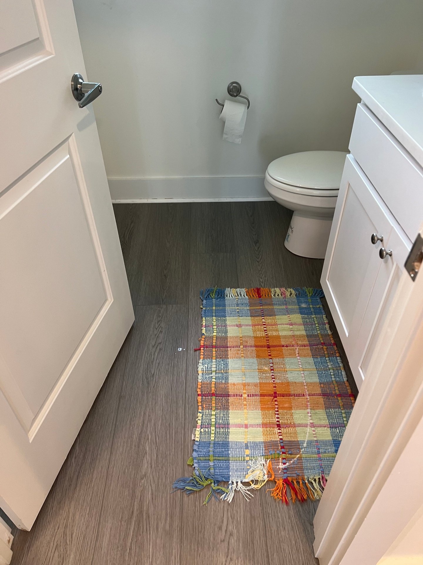 Beach condo bathroom waterproof vinyl plank flooring with coastal color palette and moisture-resistant LVP installation