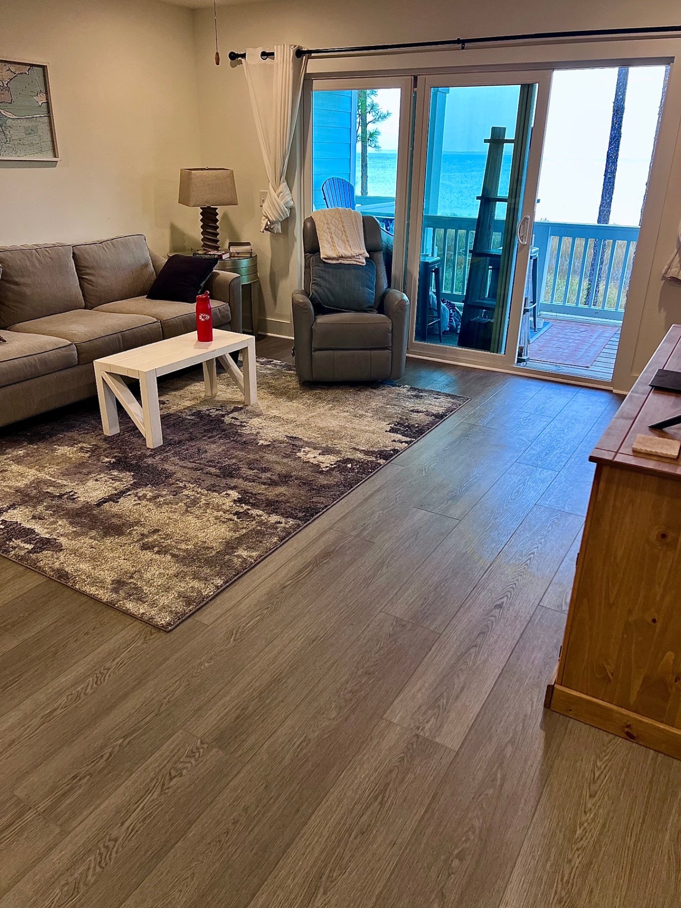 Coastal beach condo luxury vinyl plank flooring with ocean view patio doors and gray wood-look waterproof vinyl